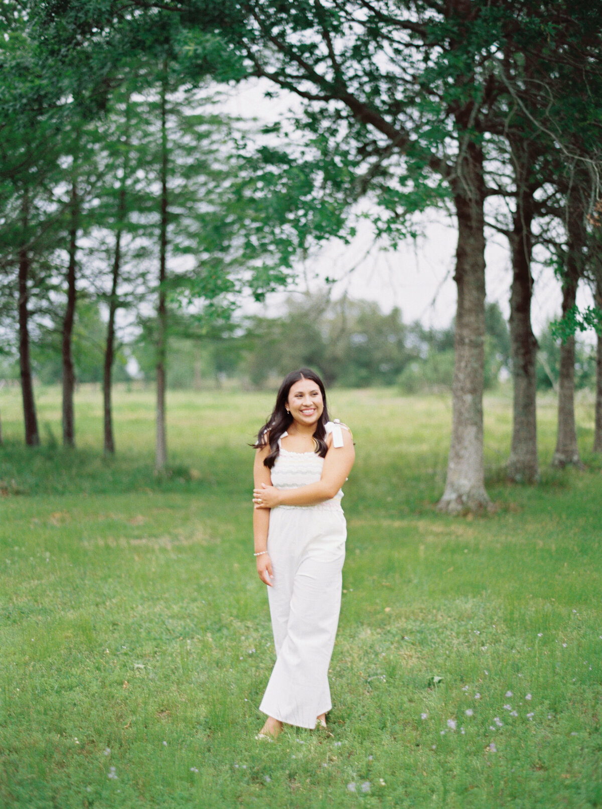 A beautiful senior portrait in the enchanting gardens of The Myrtles Plantation, surrounded by florals and history, captured on film by Morgan Alysse, Louisiana film photographer.