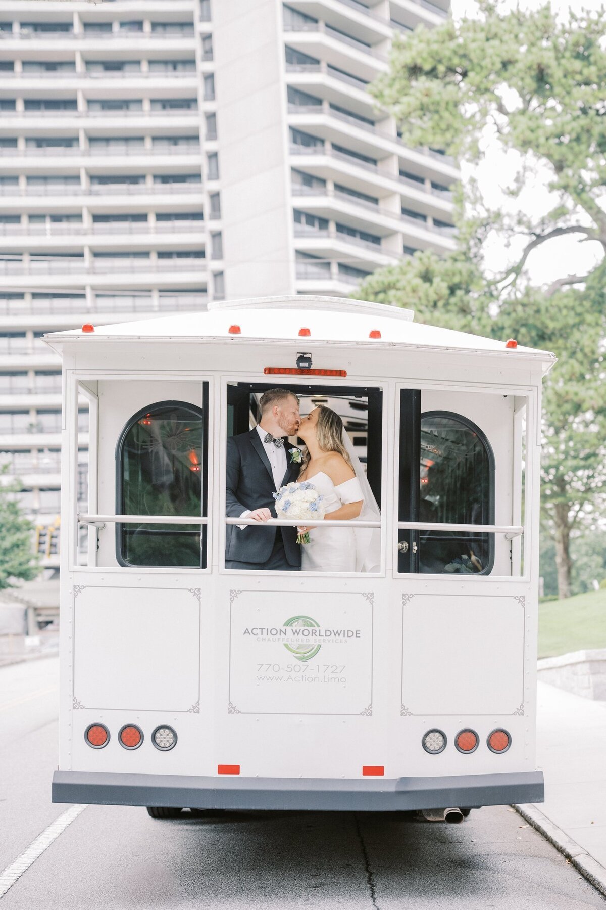 Bride and Groom kissing in the white trolley