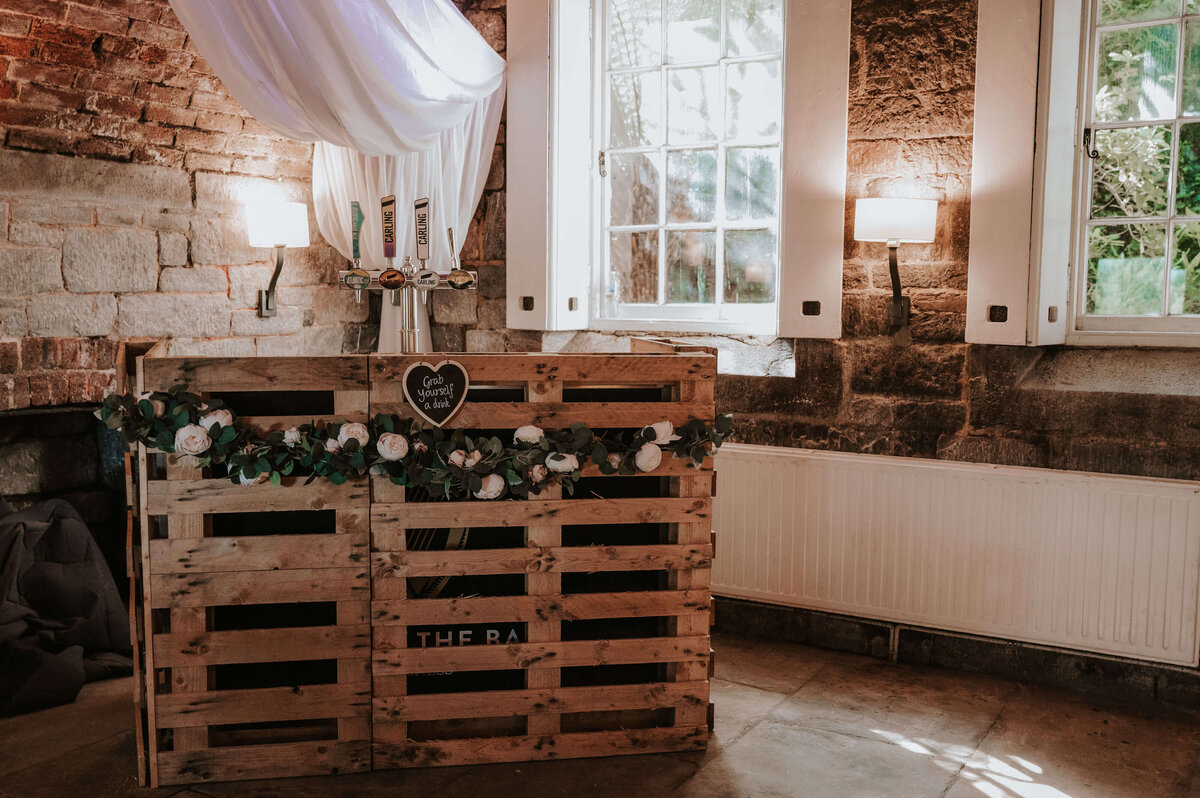 A table made out of pallets with flowers on it