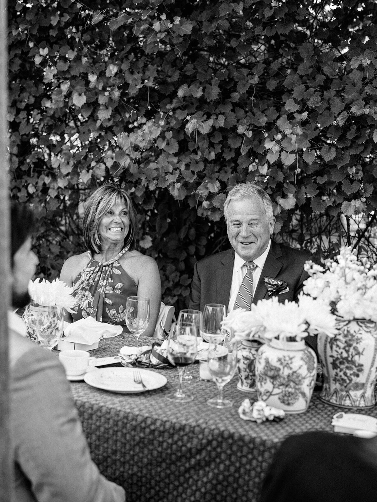 Parents laugh at welcome dinner