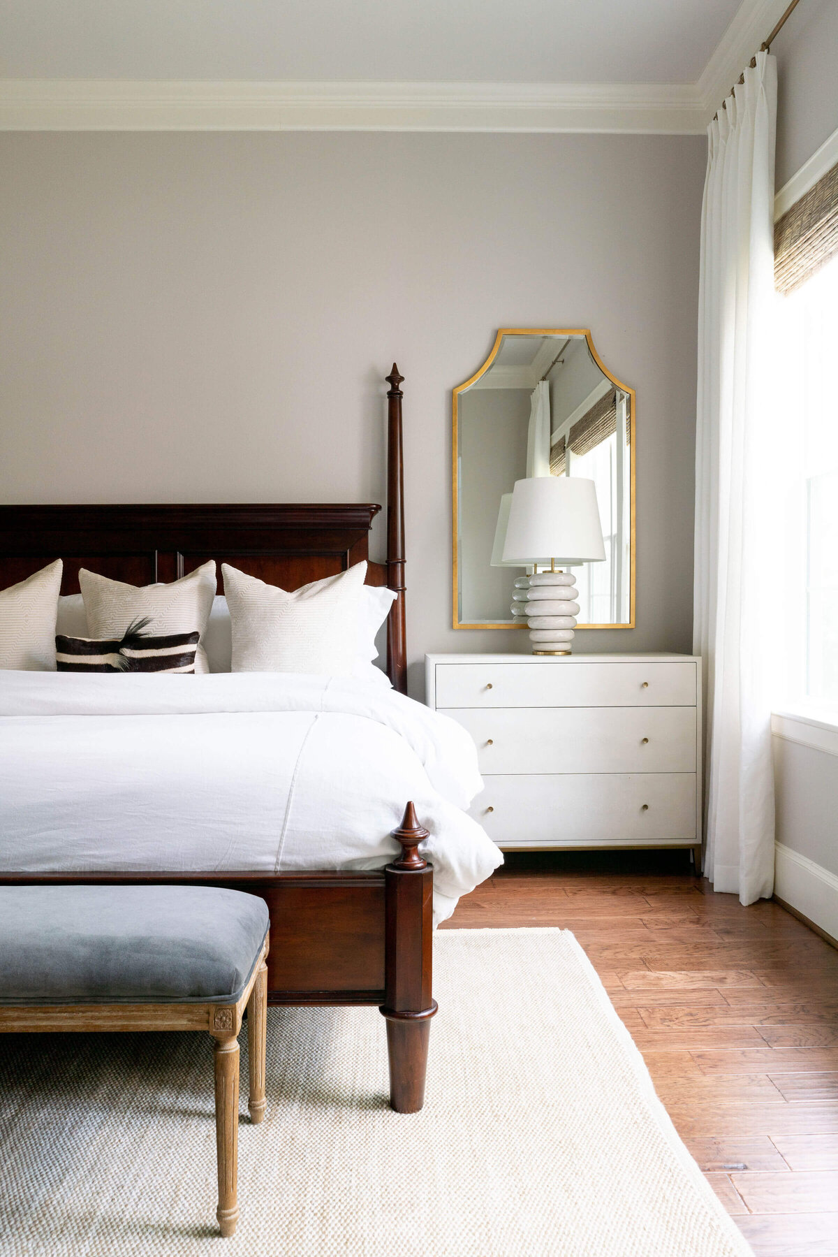oyster creek studios heathcott wooden bed with white bedspread in bedroom with white side table