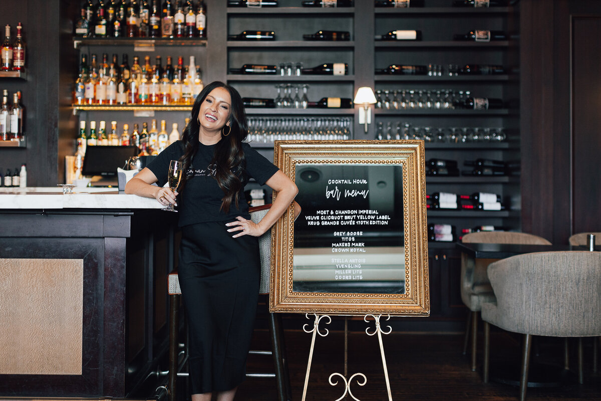 calligrapher-posing-with-cocktail-bar-menu-sign-for-brand-session-the-ballantyne-hotel-charlote