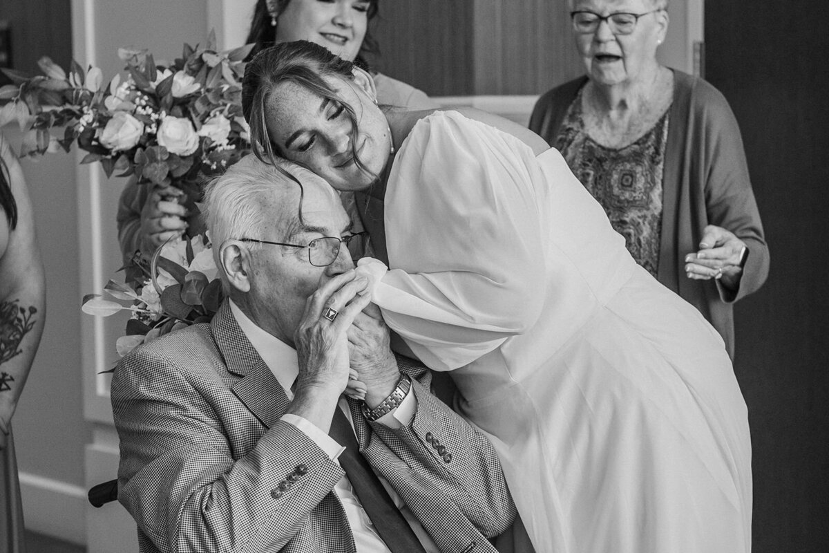 grandfather kissing brides hand after seeing her for first time