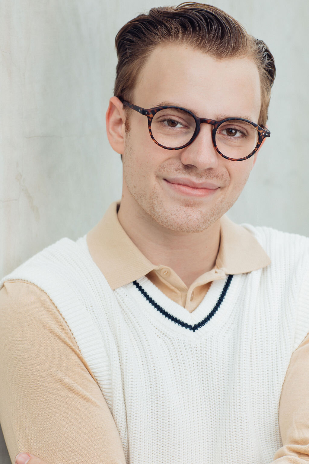 Young Man Wearing White  V-neck  Vest with Beige Inner  Long Sleeve Polo Headshot in LA