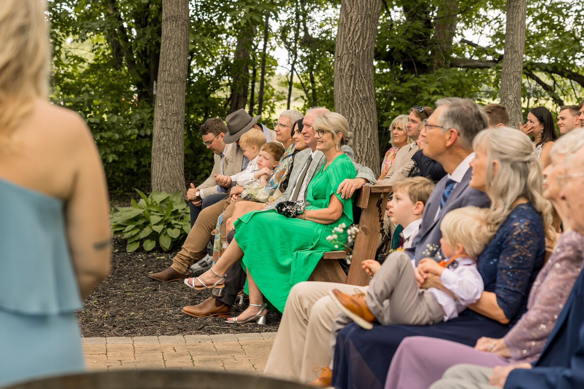 Wedding guests watching bride and groom ceremony at Carlos Creek Winery in Alexandria MN