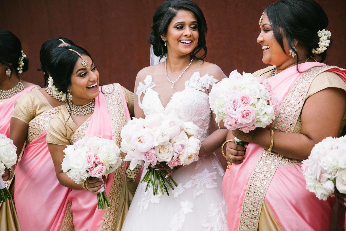 Indian wedding party with blush and cream bouquets