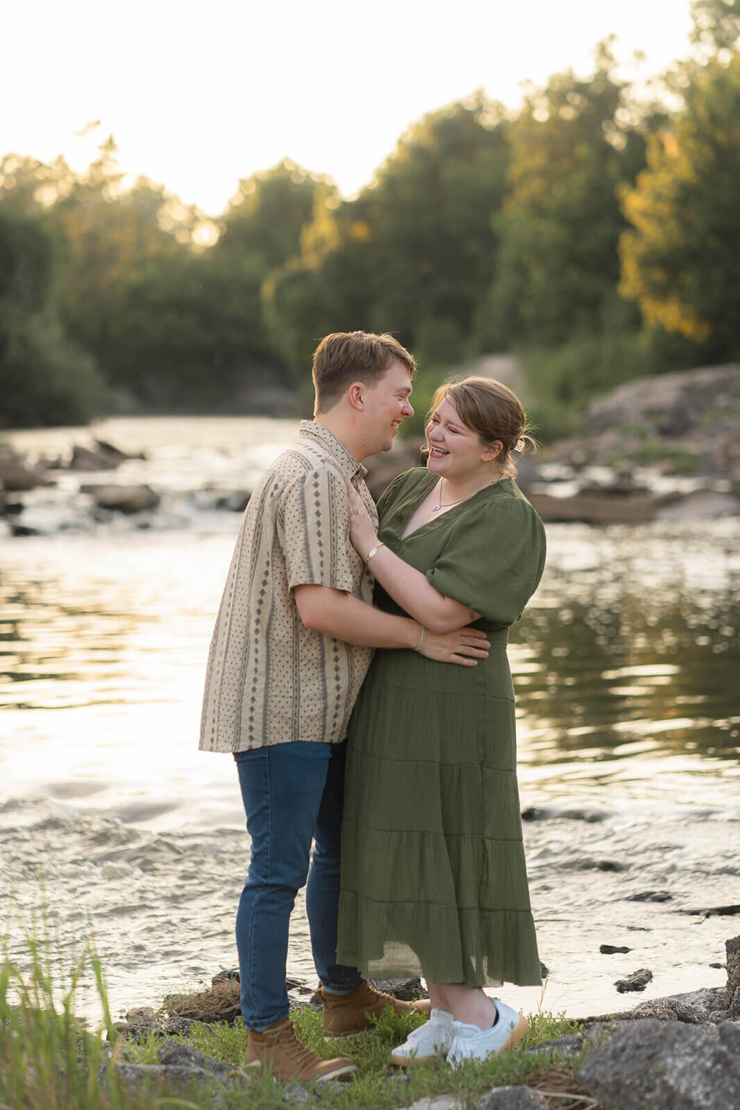 couple dancing and laughing by a creek