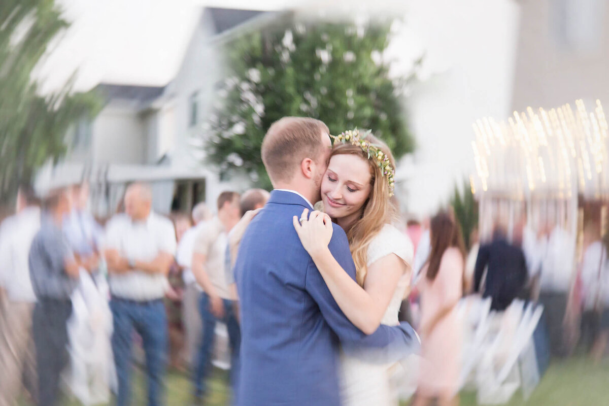 Creative wedding photography featuring blonde bride and groom dancing at wedding reception