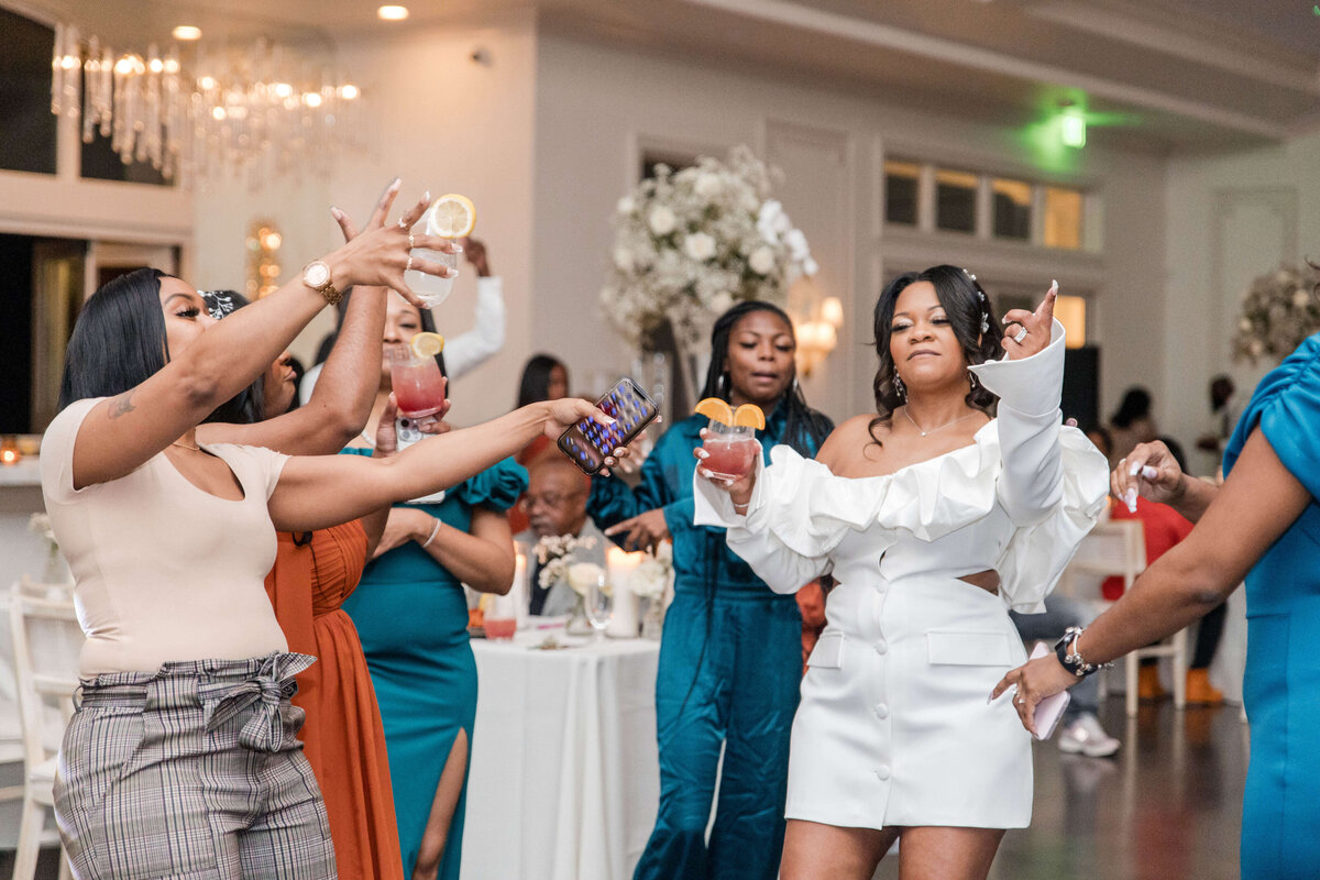 A lively moment on the dance floor as guests join the bride in a fun celebration.