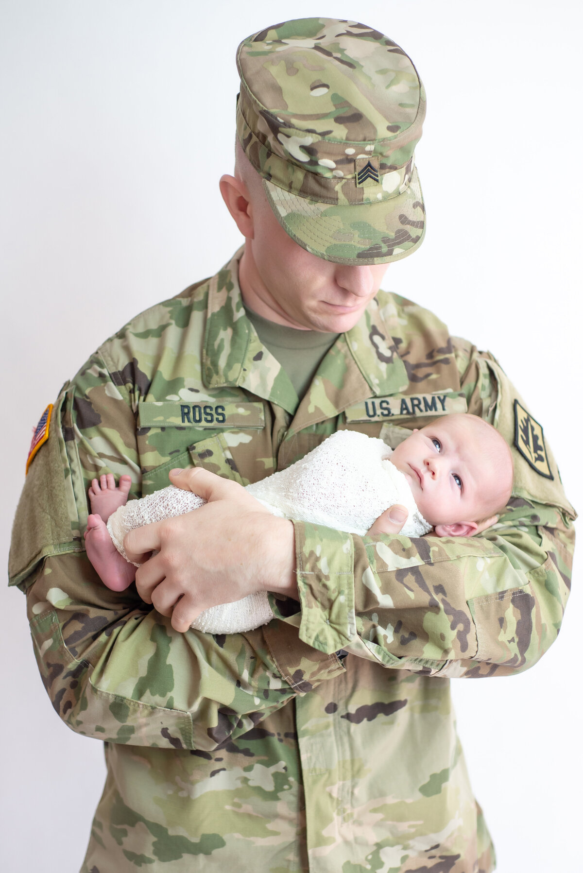 Army father holding newborn baby in Kennebunkport Maine