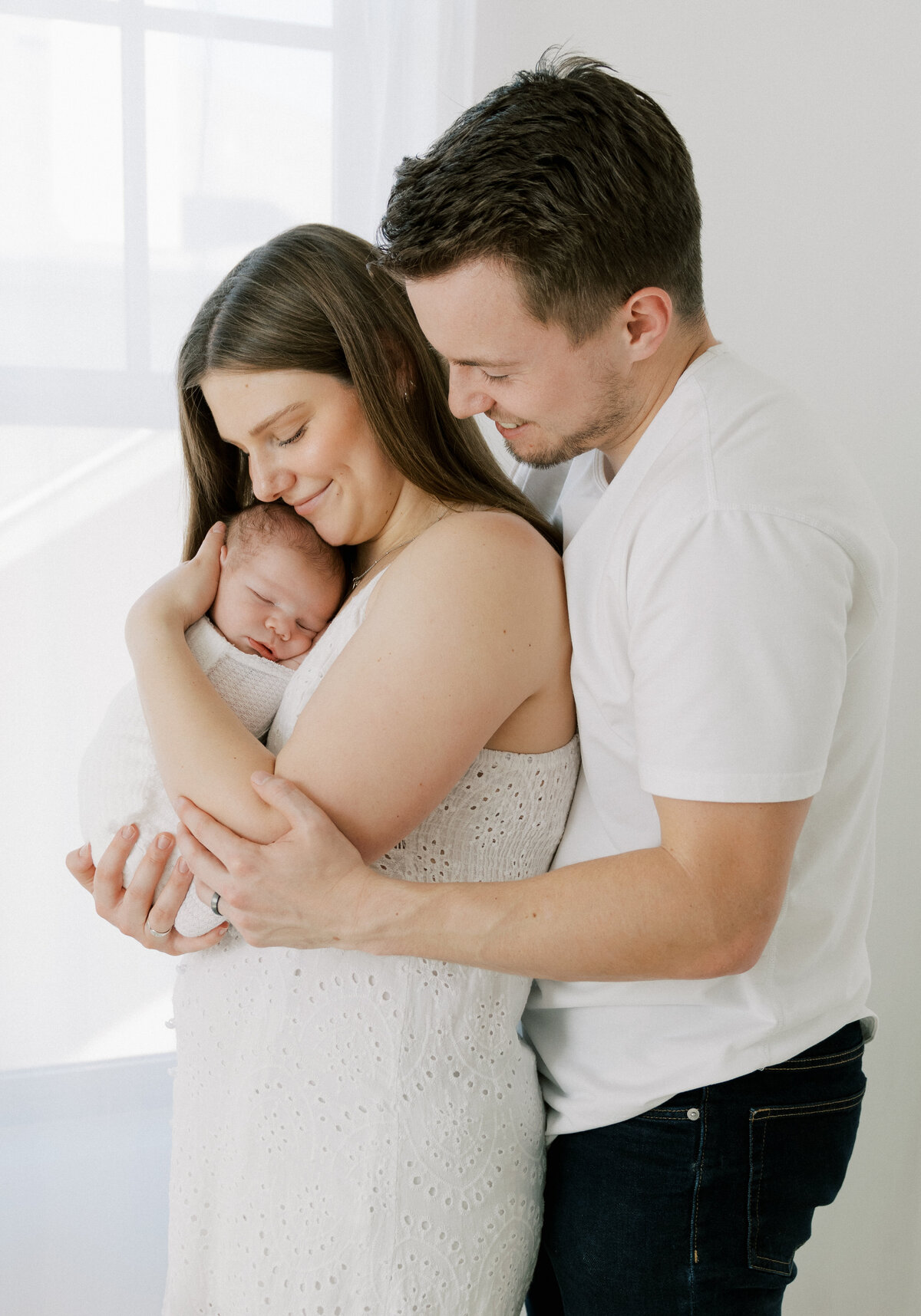 mom and dad holding newborn baby