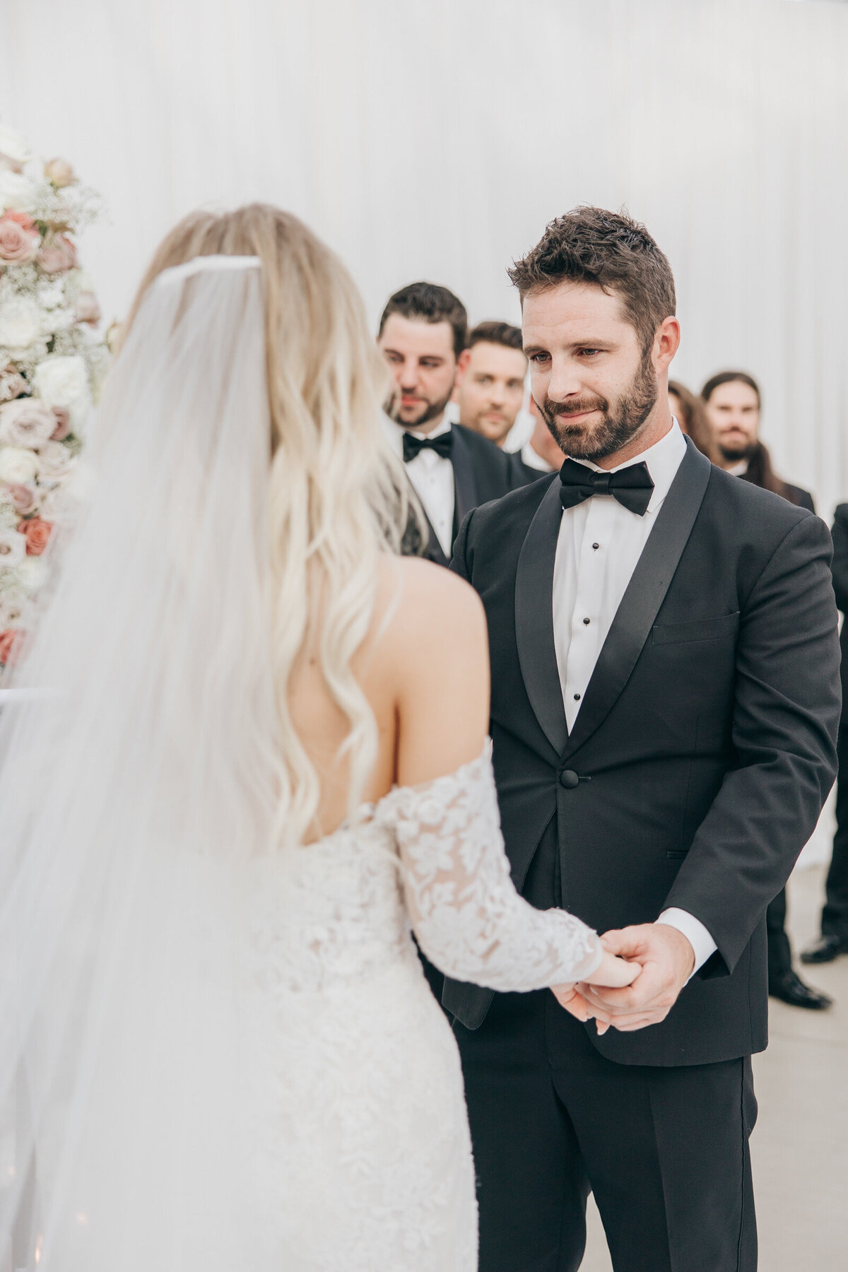 Candid moment of groom looking into bride's eye during luxurious wedding ceremony