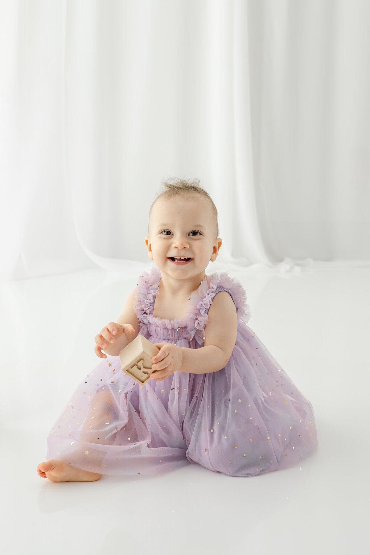 Girl in birthday hat during themed cake smash session— captured by Alliston and Barrie cake smash photographer.