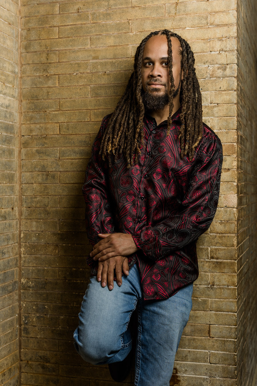 portrait-man-dreadlocks-brick-wall-13246