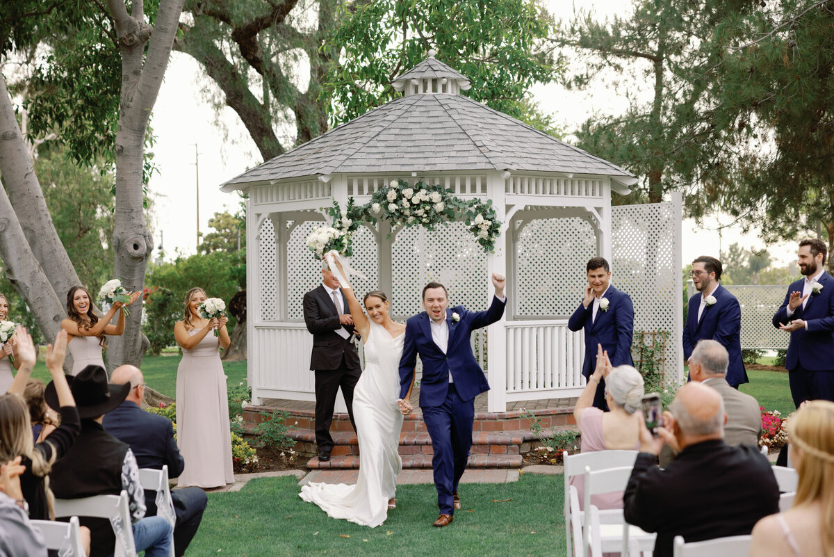 bride with bridesmaids laughing  and walking