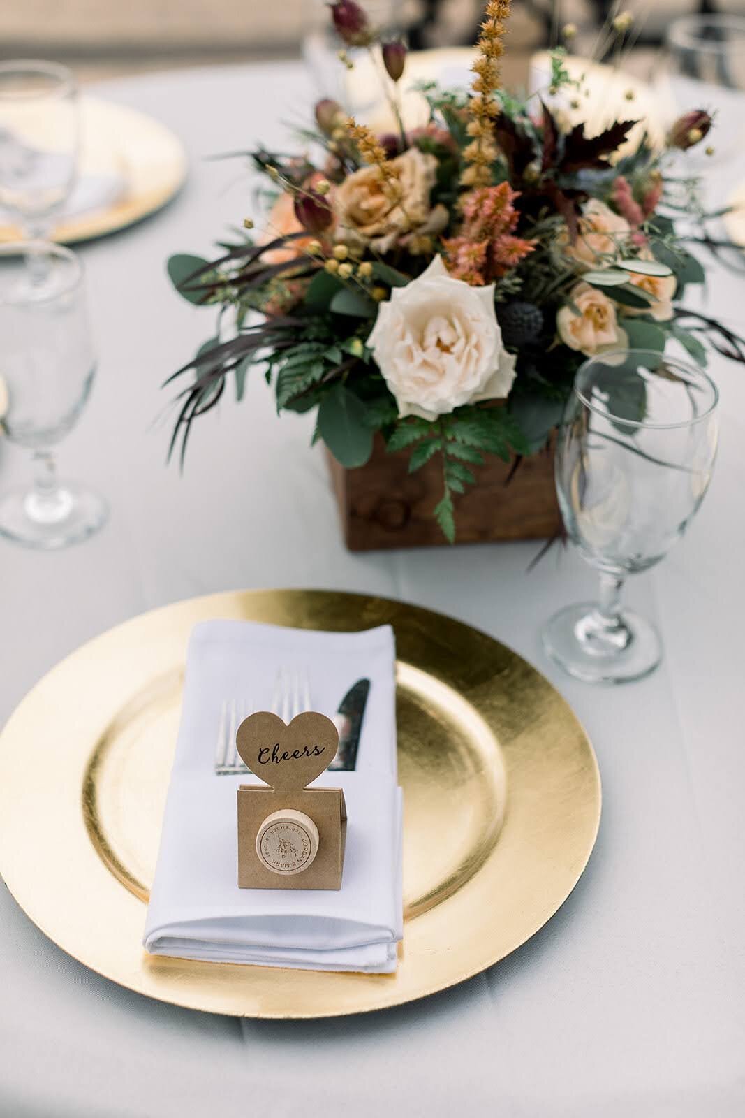 Close up of place settings and beautiful floral arrangement at wedding.