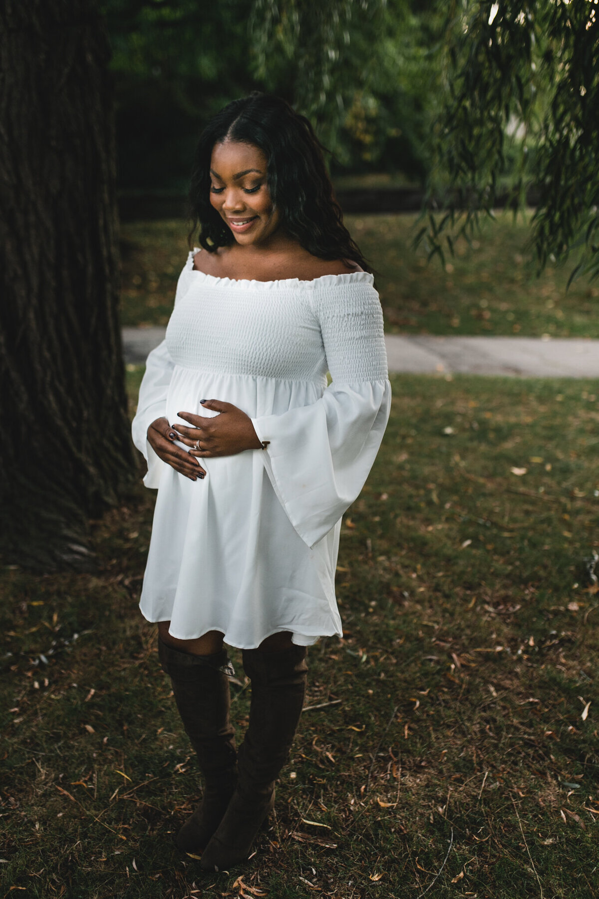 Maternity shot with soon to be mom wearing white dress.