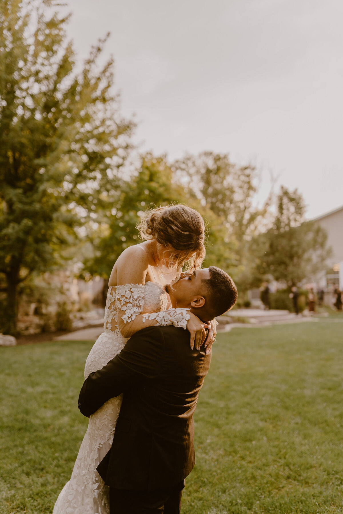 groom-lifting-bride-golden-hour-romantic-des-moines-wedding-photographer-storyteller-collective-photo-co