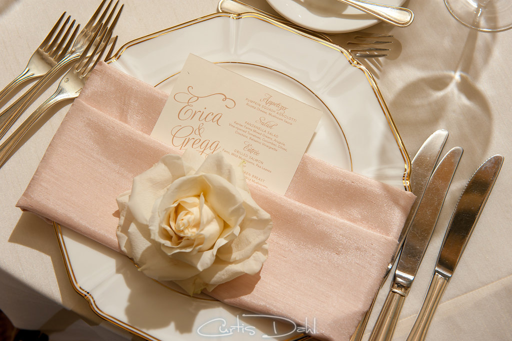 menu  tucked into napkin with rose