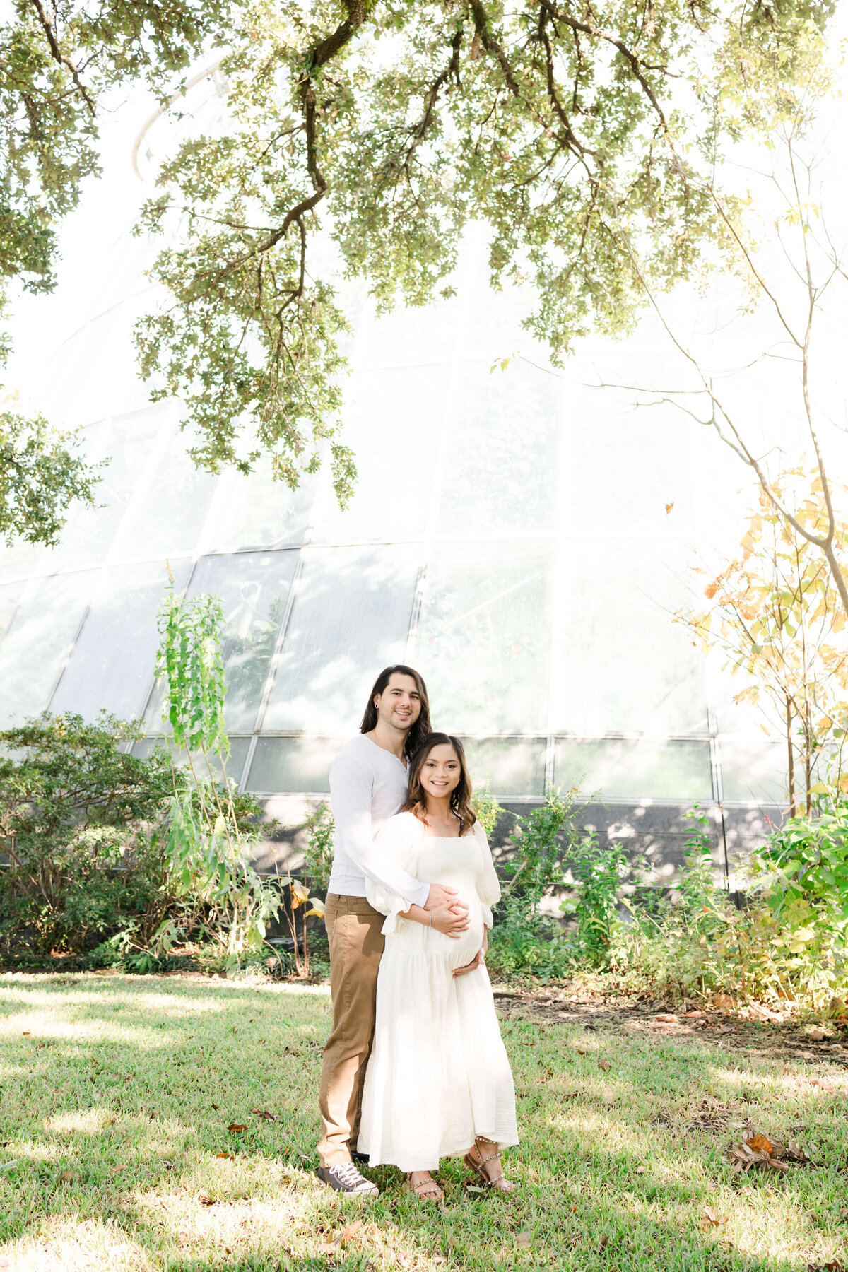 an expecting couple posing together
