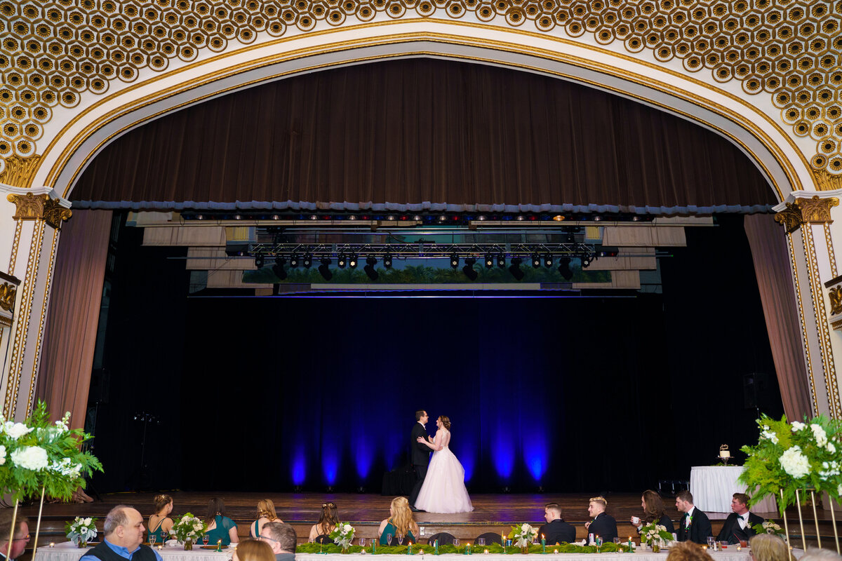 Bride and groom share their first dance on stage at the Columbus Athenaeum.