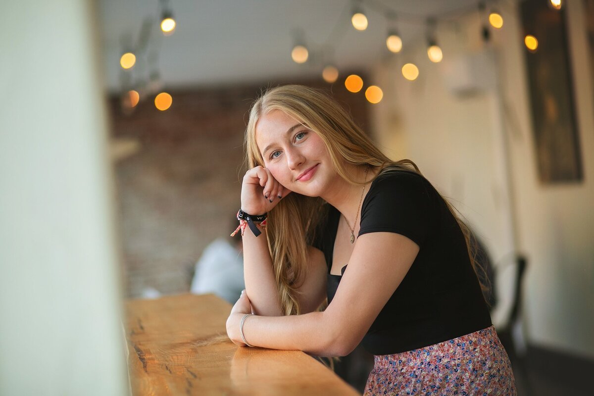 senior-photo-session-in-a-cozy-cafe-with-string-lights-in-danville-indiana-rural-west-side-of-indy
