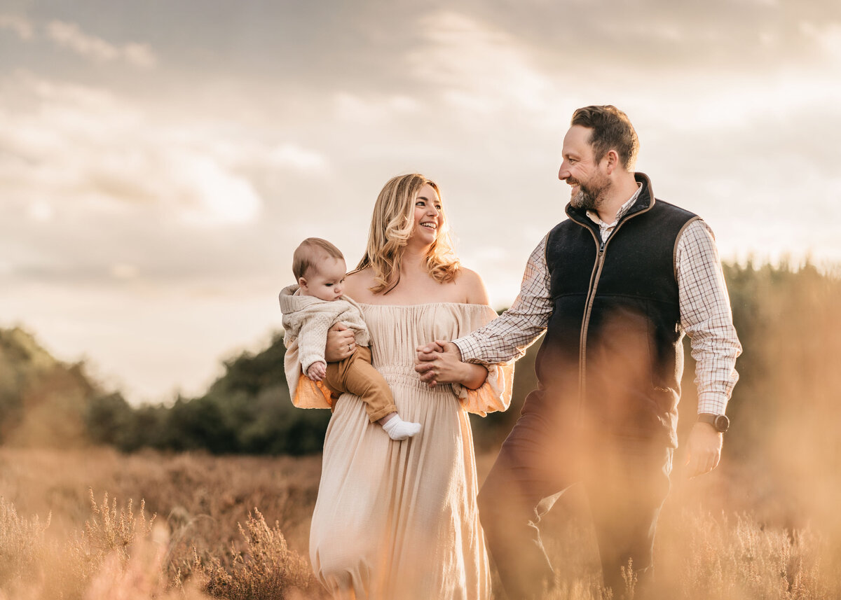 Photo of a family walking holding hands outside at sunset during a family photoshoot in Shrewsbury