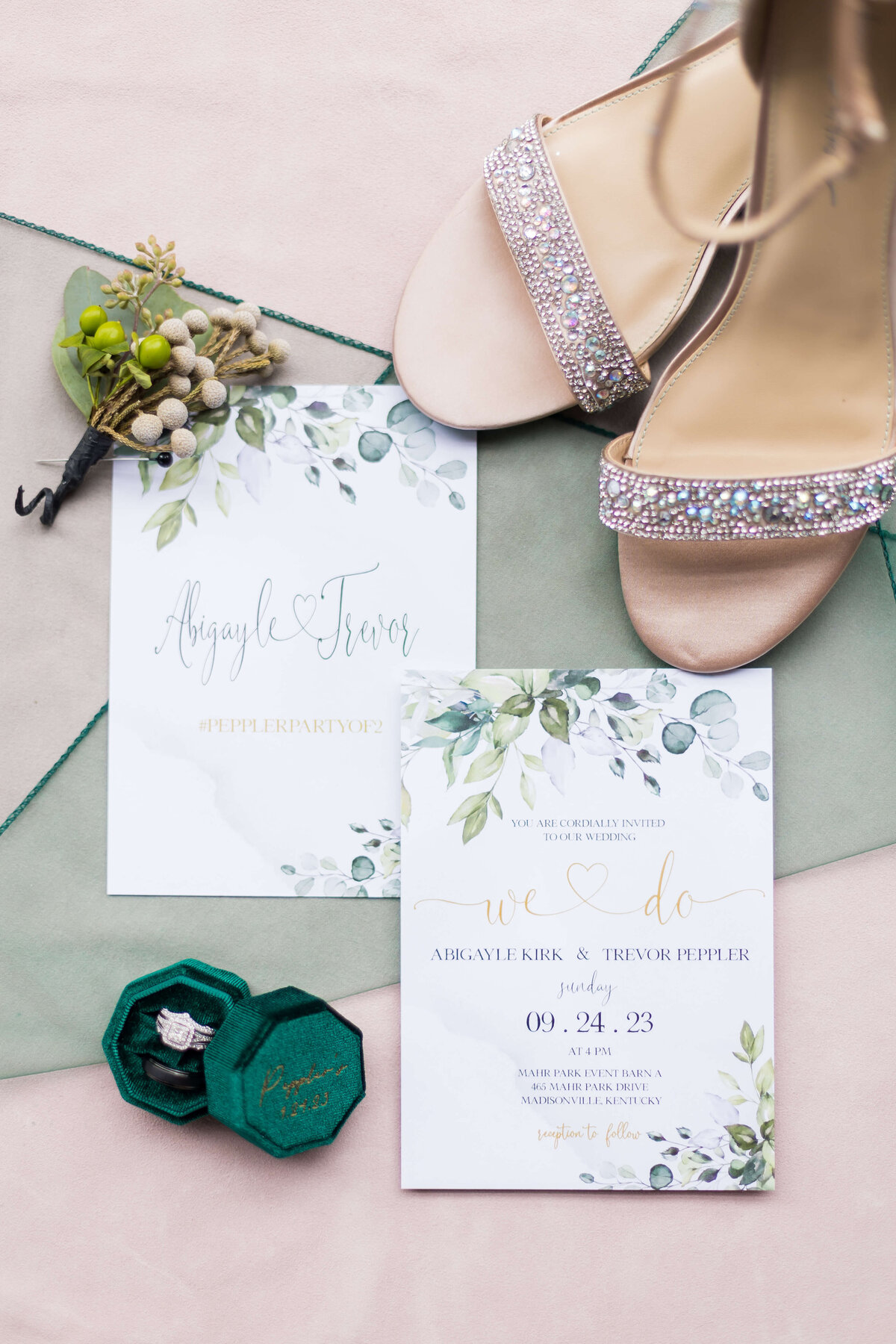 wedding invitation flat lay with wedding rings and shoes