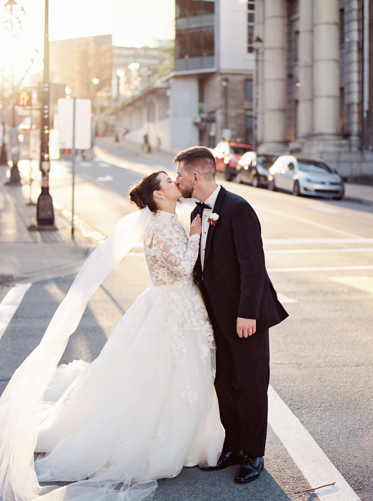 Bride and groom kissing in street in Halifax, Nova Scotia
