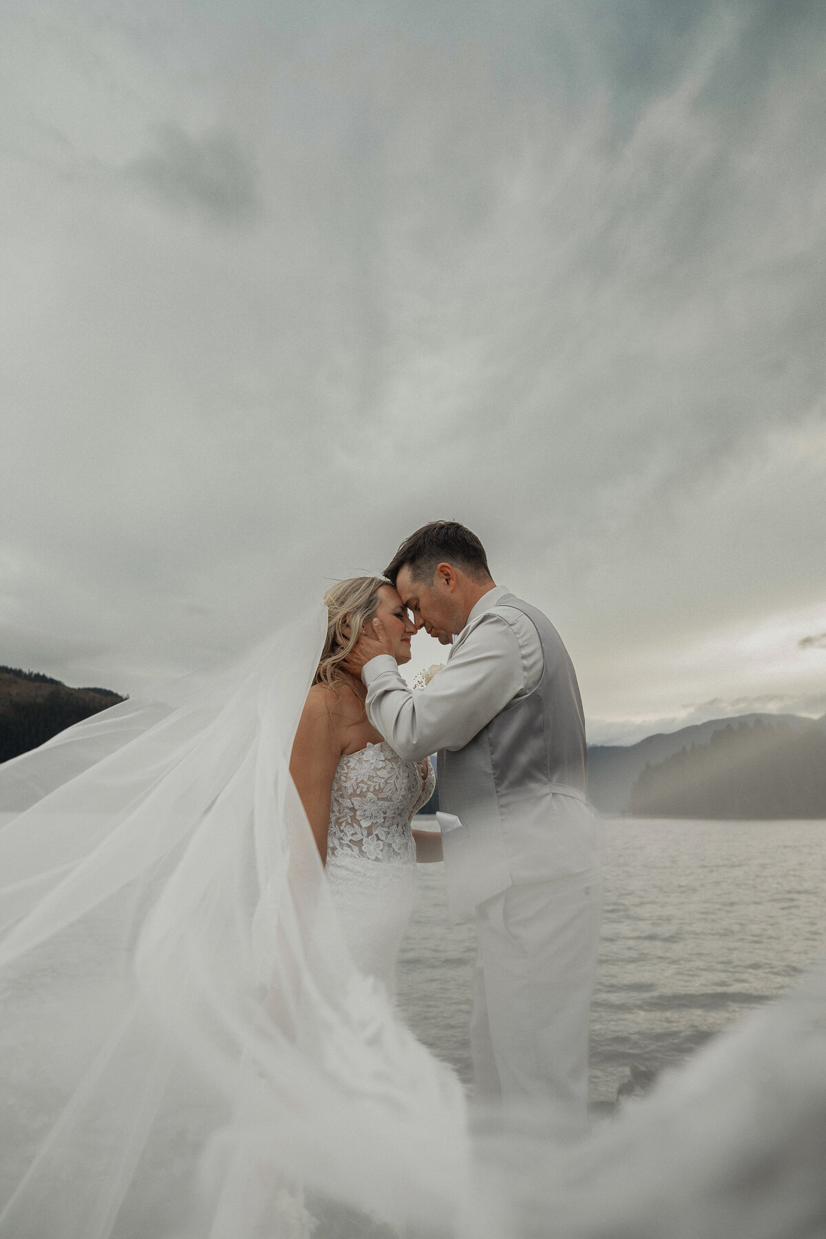 Bride and groom at comox lake at the fish and game club during their wedding portraits by latitude 49 photography