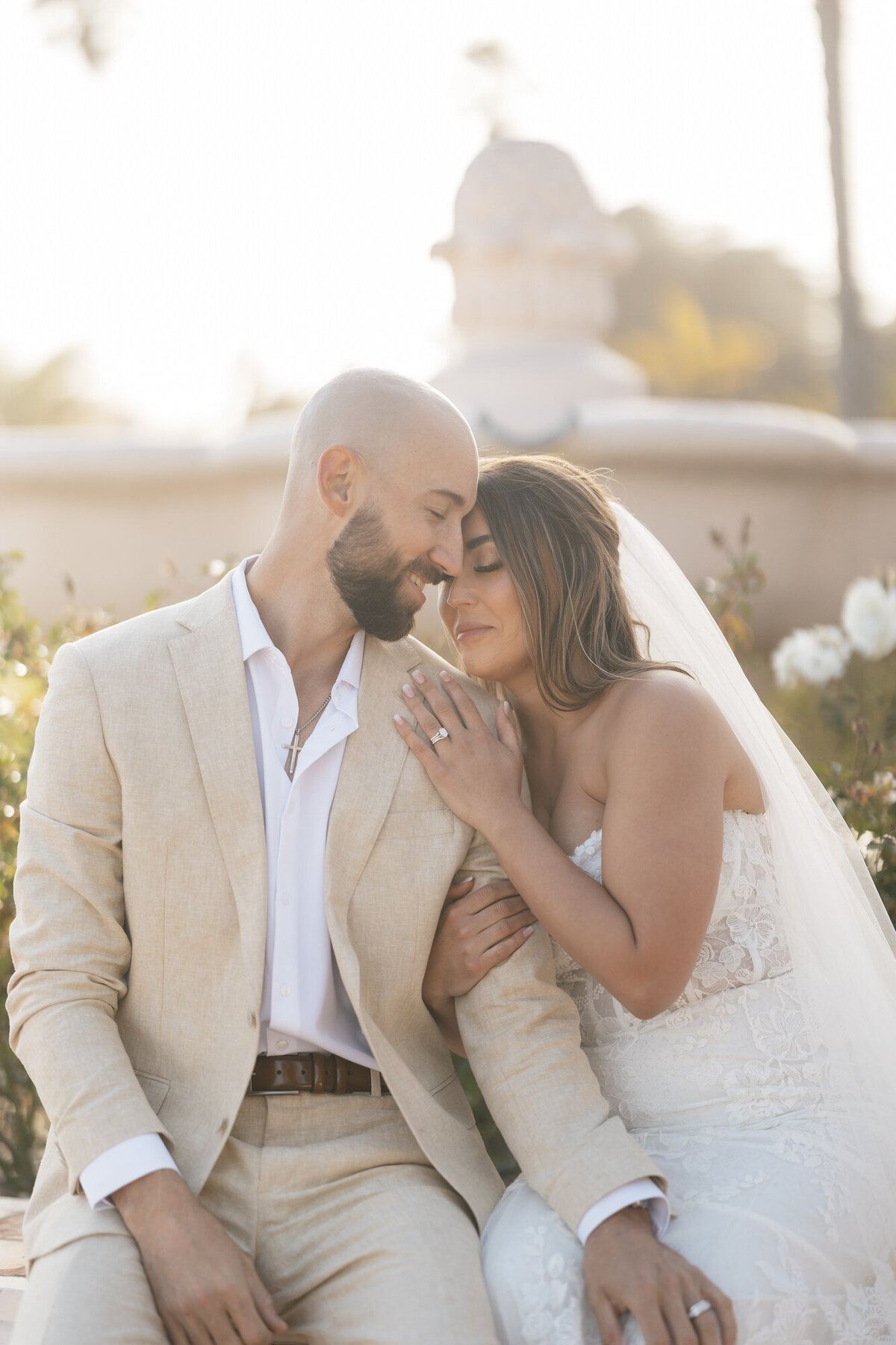 Bride and groom embracing each other during portraits at Hilton Beachfront Resort Santa Barbara in California