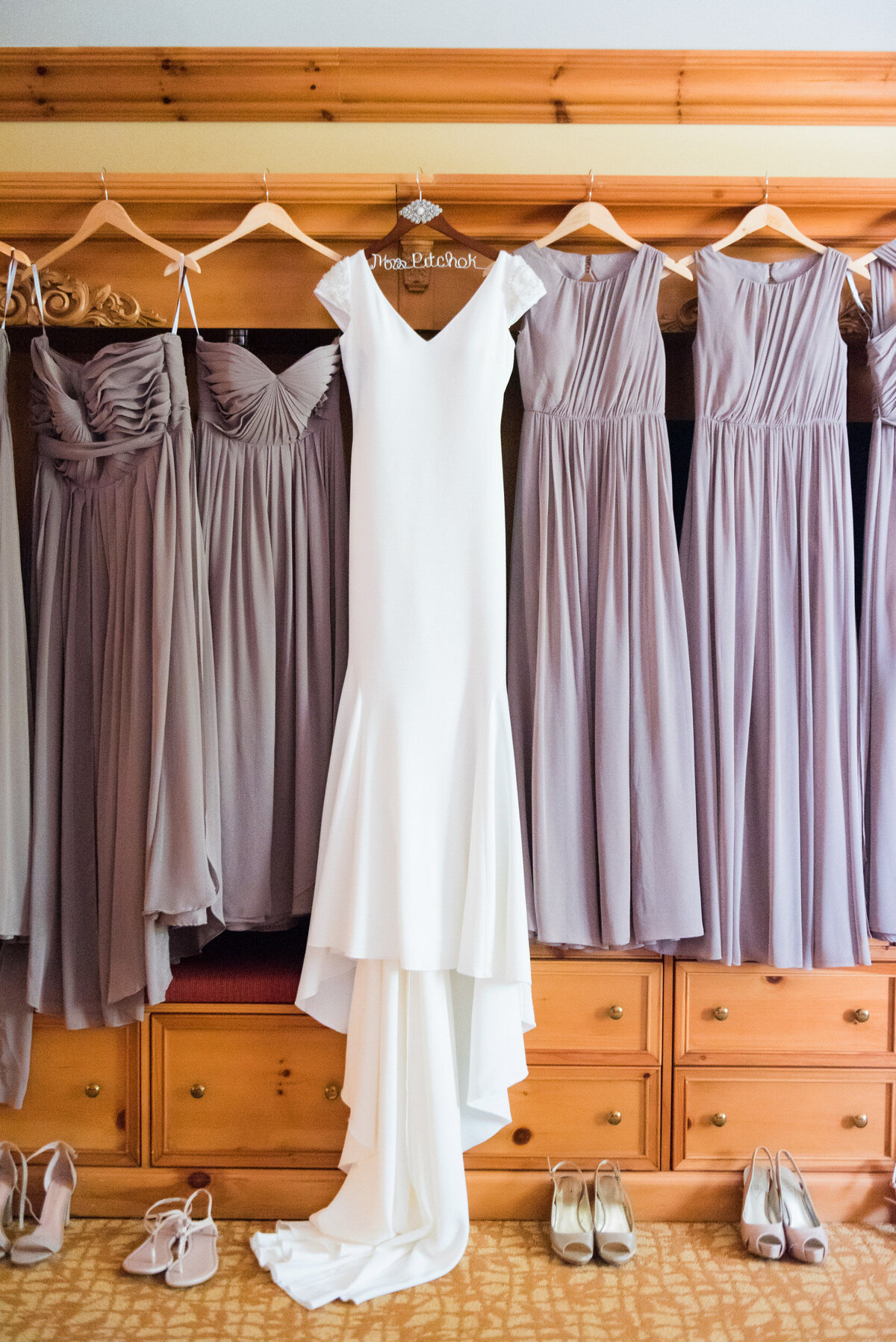 bride and bridesmaids dresses hanging up in their getting ready room at oglebay resort