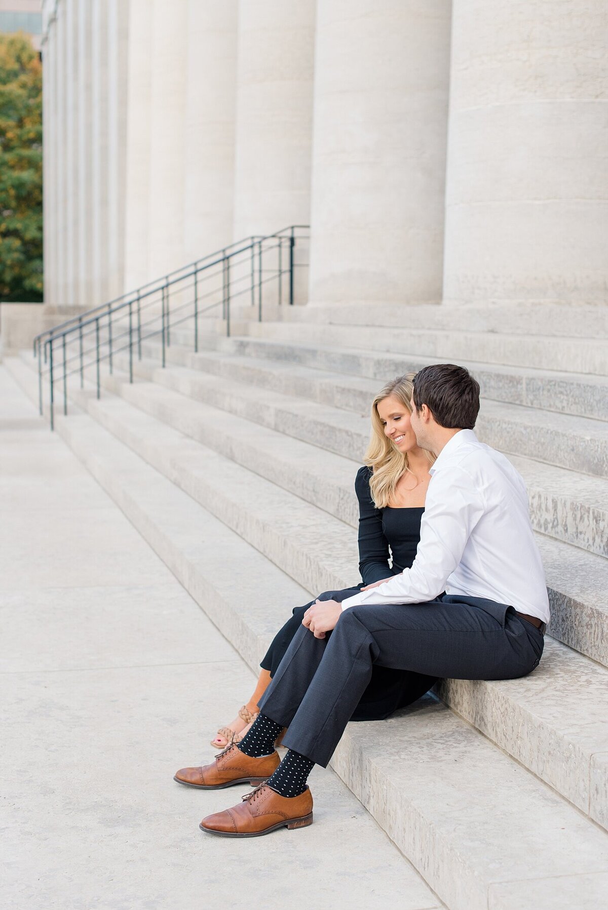 Groom kissing bride on steps of Ohio State House photographed by Columbus, Ohio wedding photographers