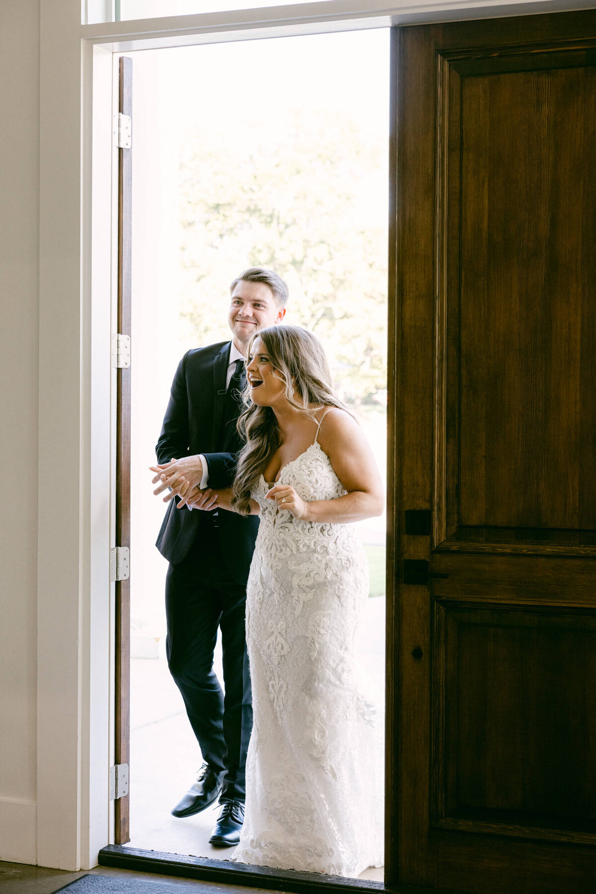 A wedding photo of the bride and groom seeing their reception area for the first time