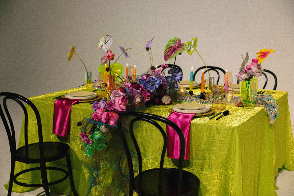 A brightly decorated reception table with chairs in front of it.