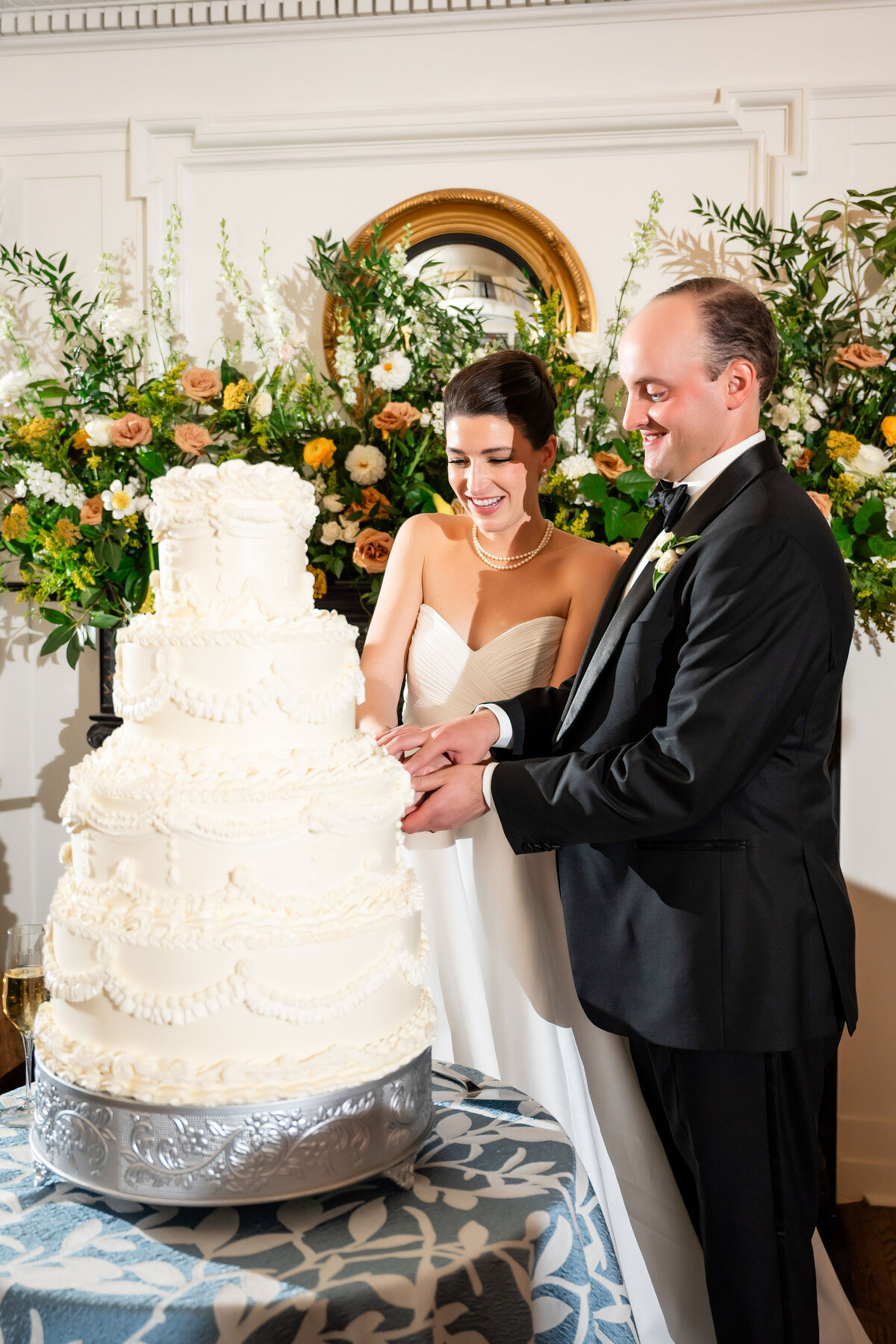 bride and groom cutting a large wedding cake at pittsburgh golf club
