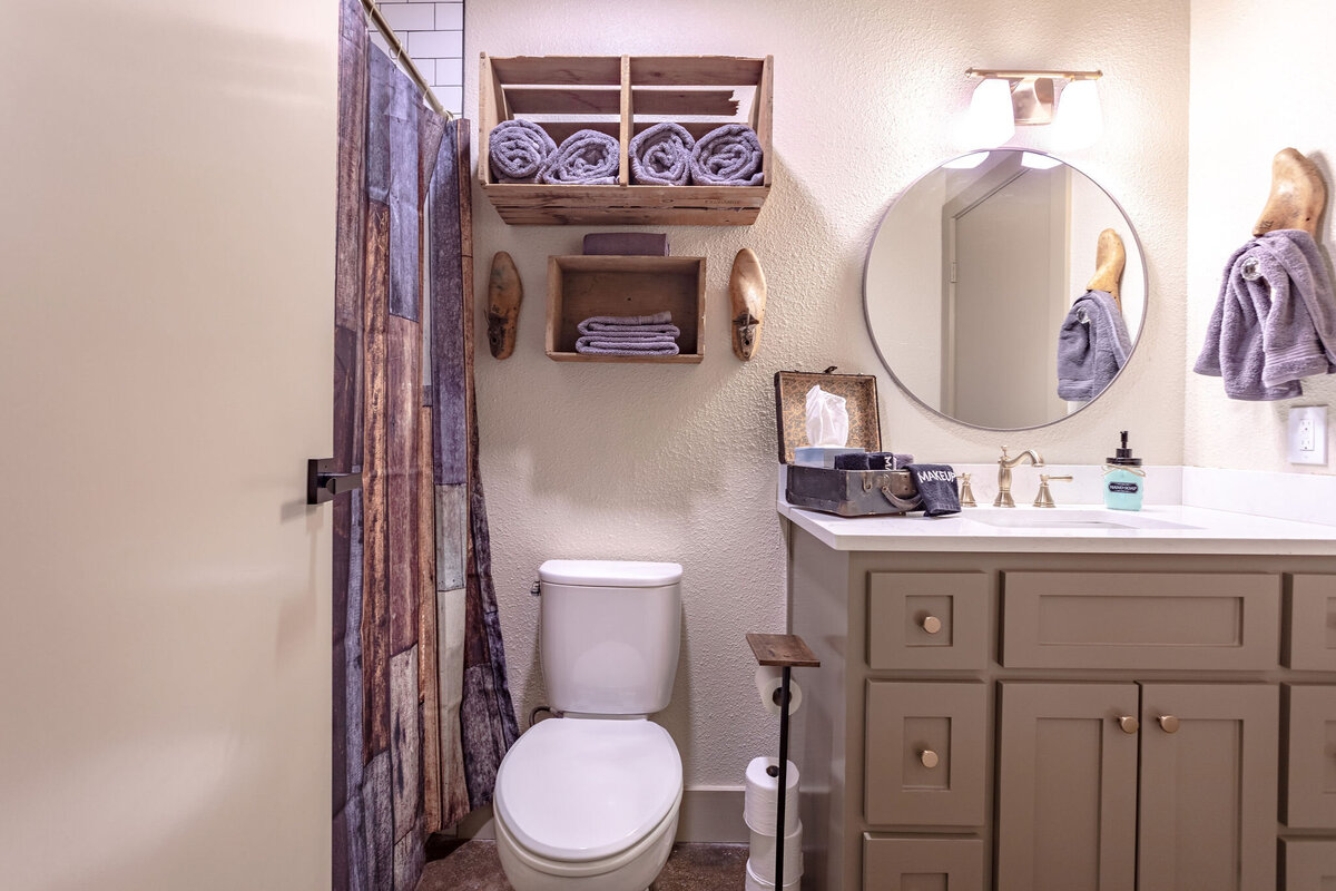 Bathroom with large vanity in this 2-bedroom, 2-bathroom vacation rental condo for four guests in the historic Behrens building with free parking, free wifi, vintage decor, and easy access to Baylor University, Magnolia Silos, and Cameron Park Zoo in downtown Waco, TX.