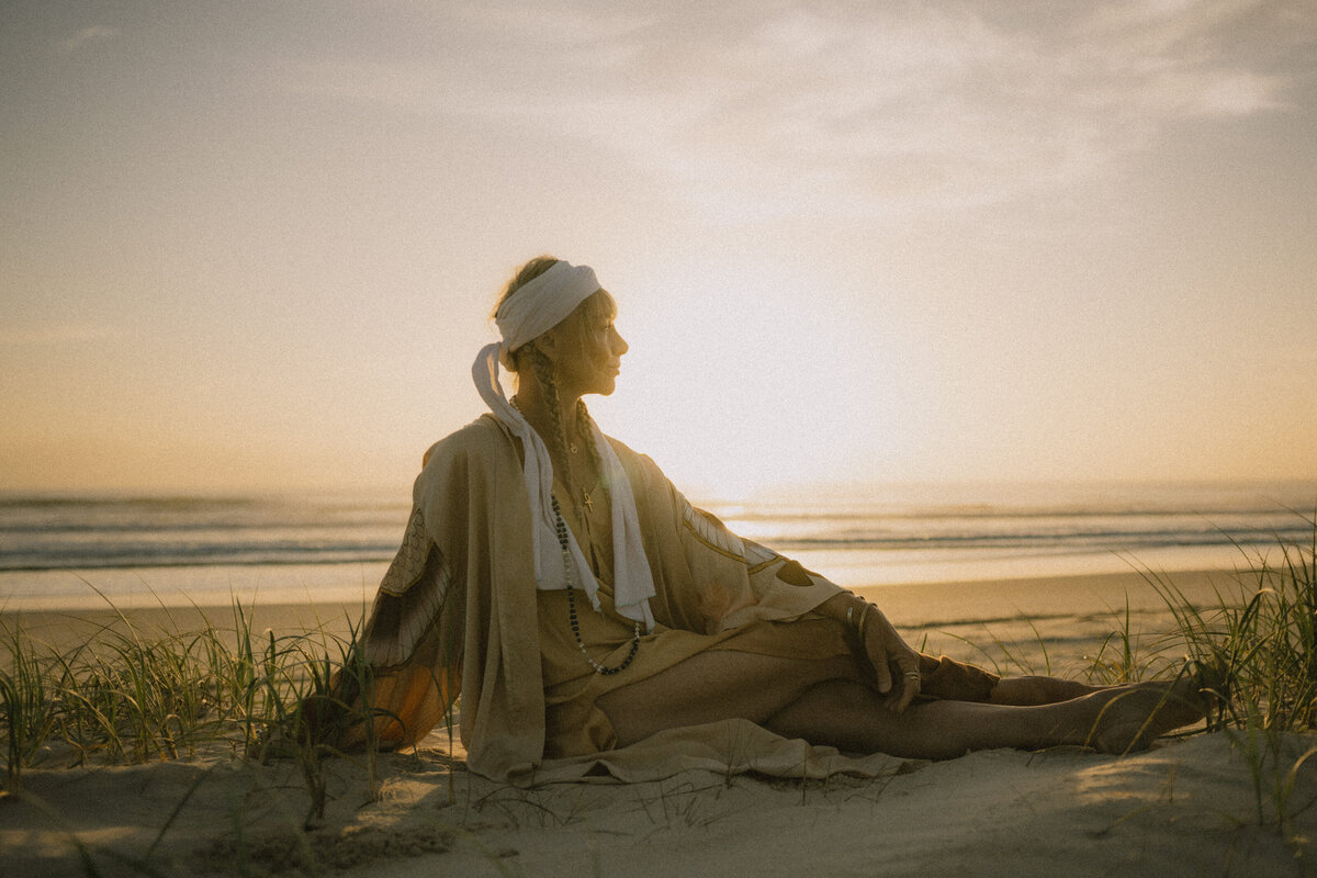 HarJiwan sitting on beach looking away