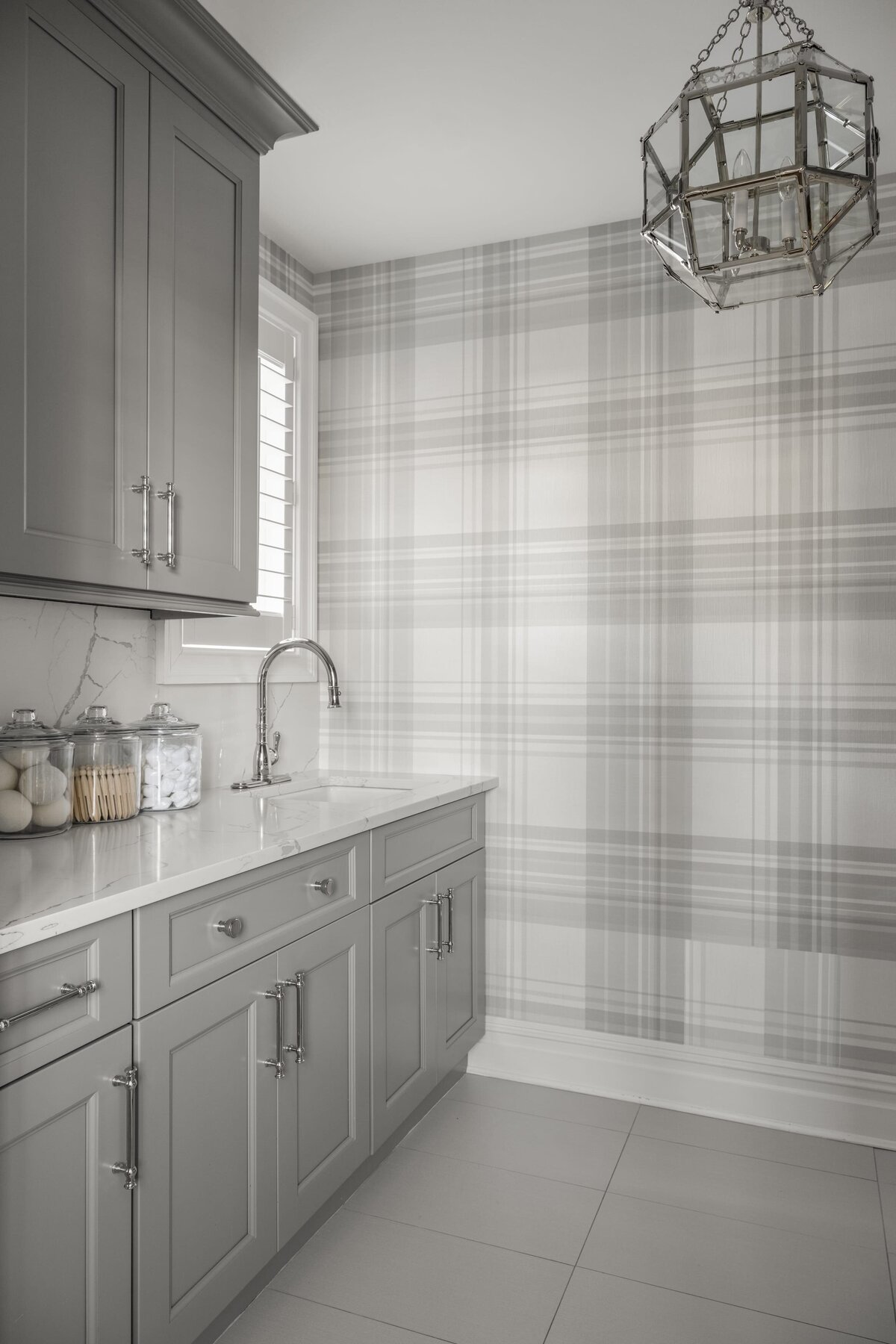candra lynn interiors ocean port project laundry room with sink and striped wallpaper