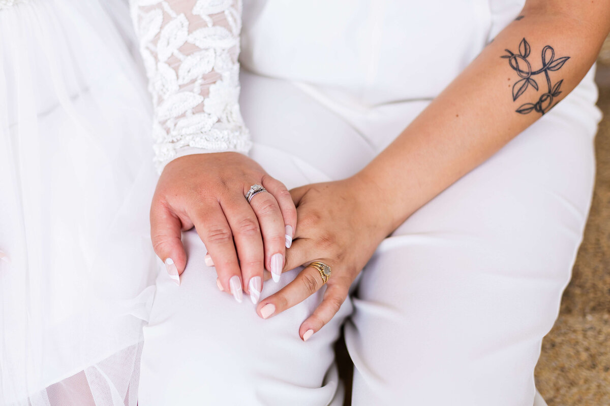 Couple wearing white outfits at LGTBQ wedding in Centennial Park, Nashville,TN