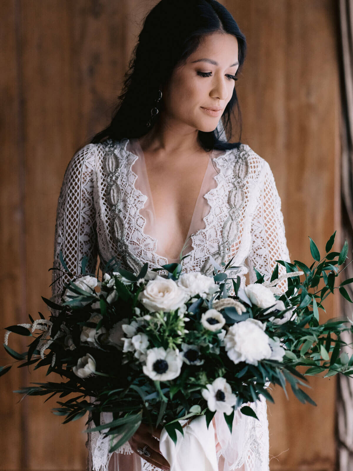 The gorgeous bride is holding a beautiful flower bouquet in Khayangan Estate, Bali, Indonesia. Image by Jenny Fu Studio