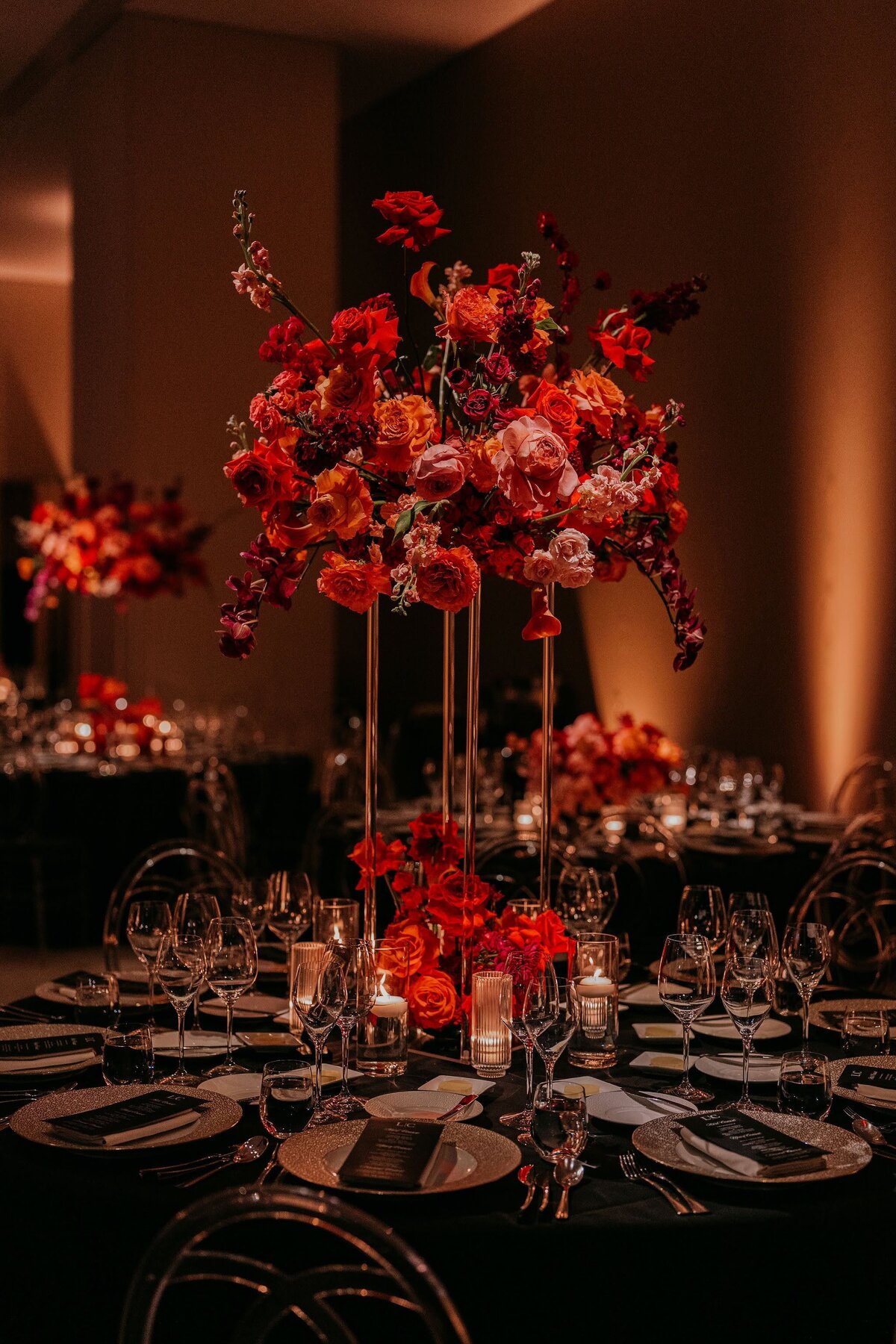 Philadelphia Four Seasons Wedding reception tall red floral arrangements by Philadelphia wedding florist Sebesta Design