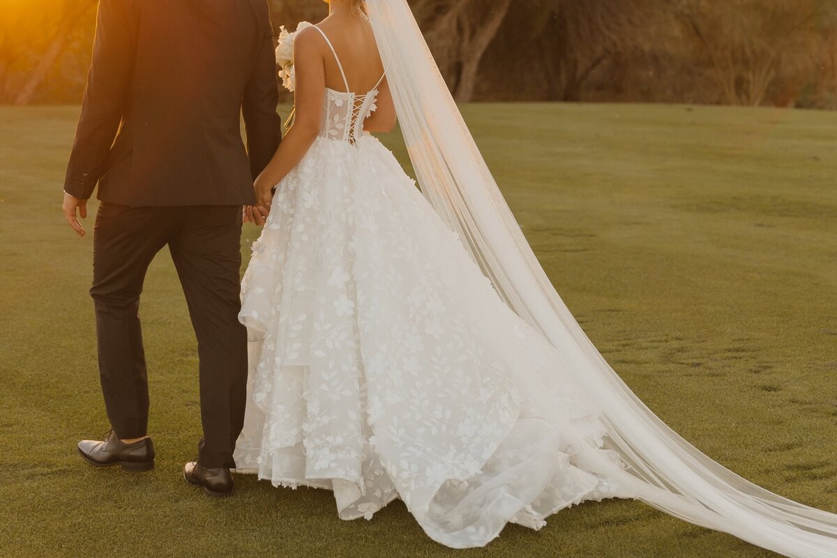bride and groom walk away after wedding ceremony in arizona