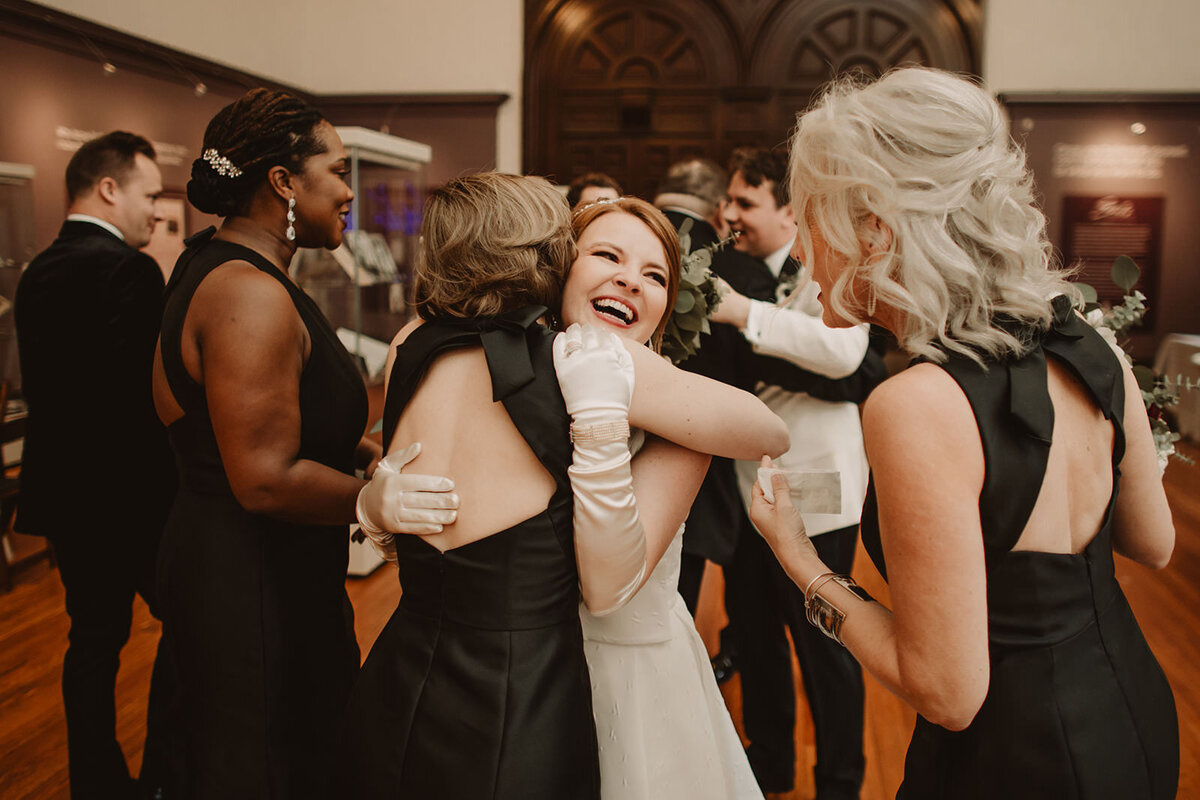 A newlywed hugging a wedding guest 
