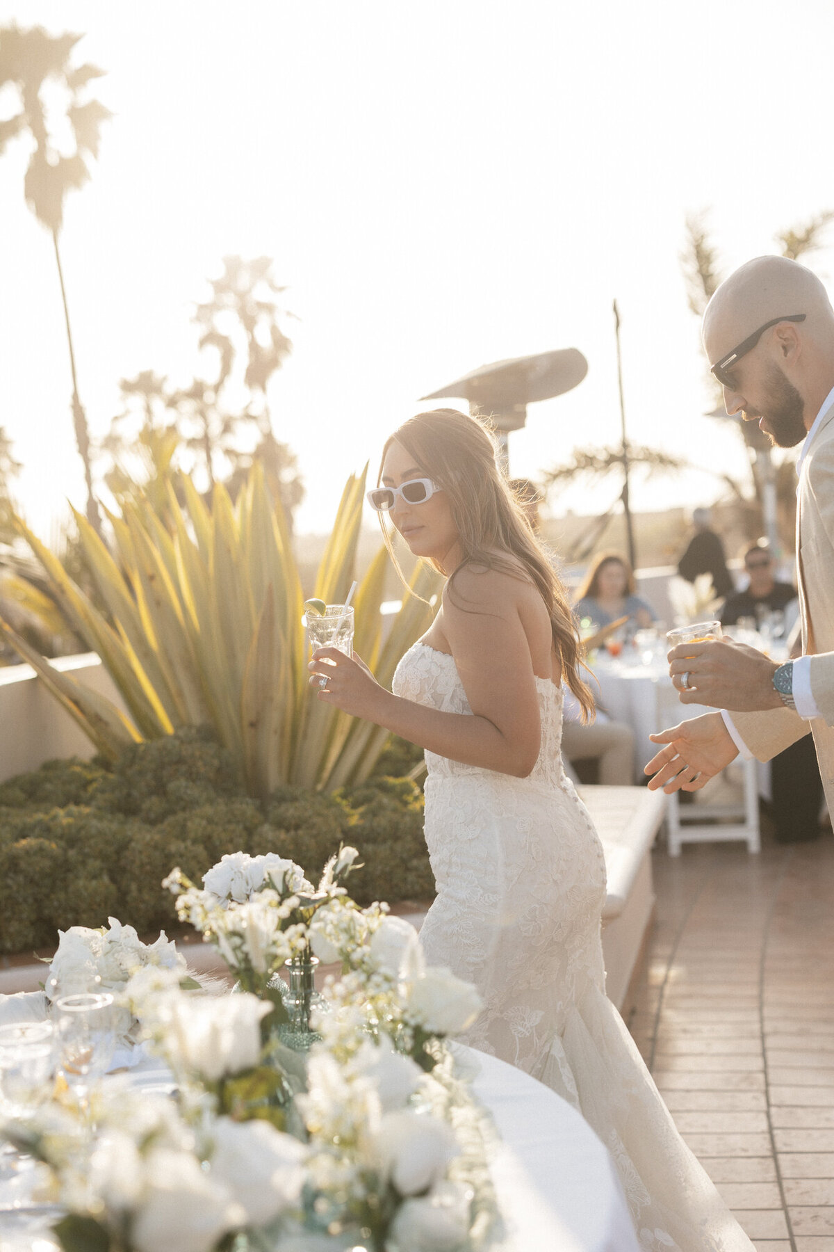 Bride and groom walking to sweetheart table at reception at Hilton Beachfront Resort Santa Barbara
