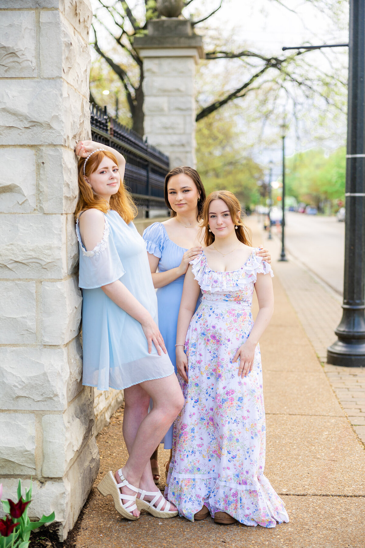 3 girls in pastel dresses posing outside the MO botanical gardens