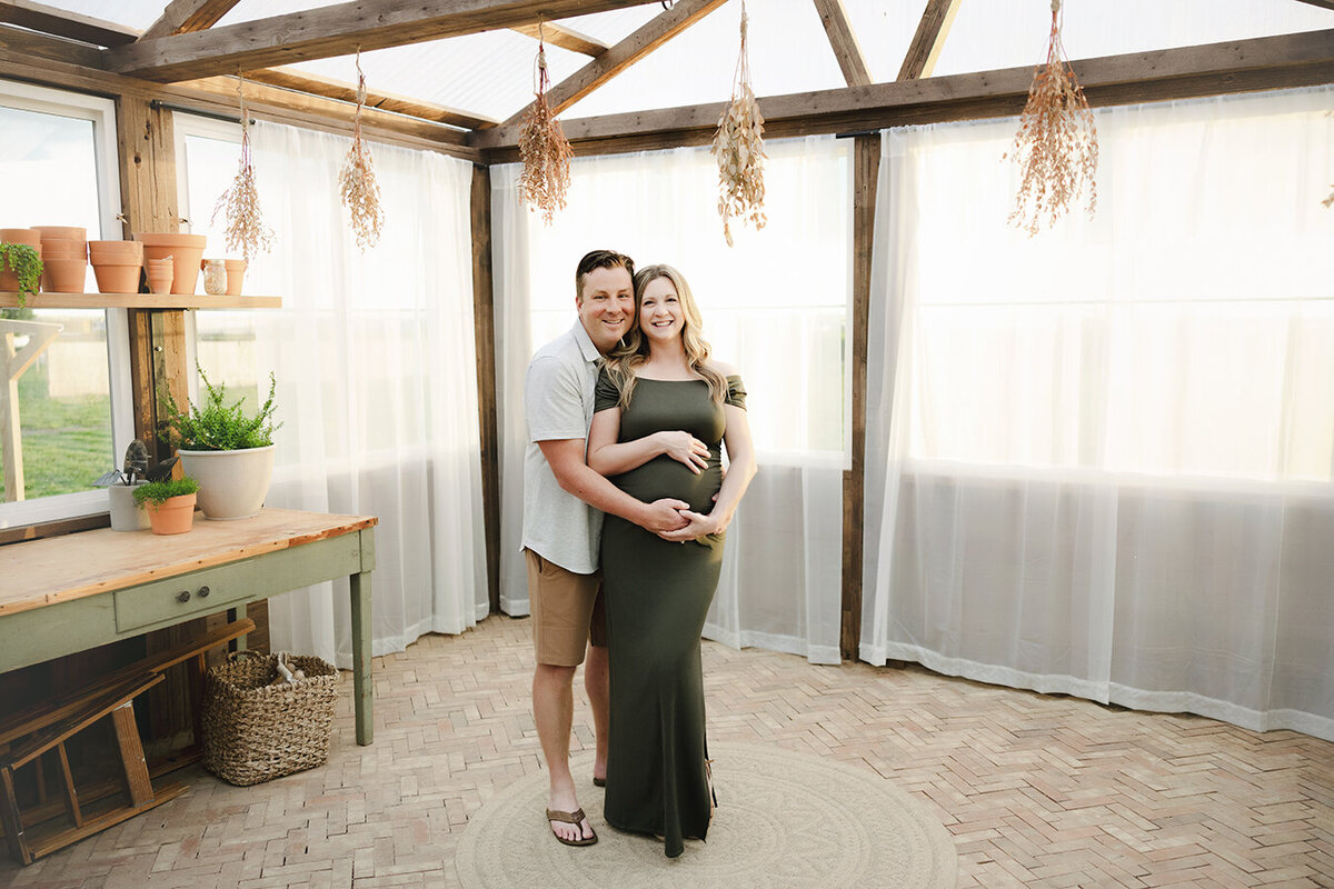 Pregnant mom poses with baby's father for maternity portraits.