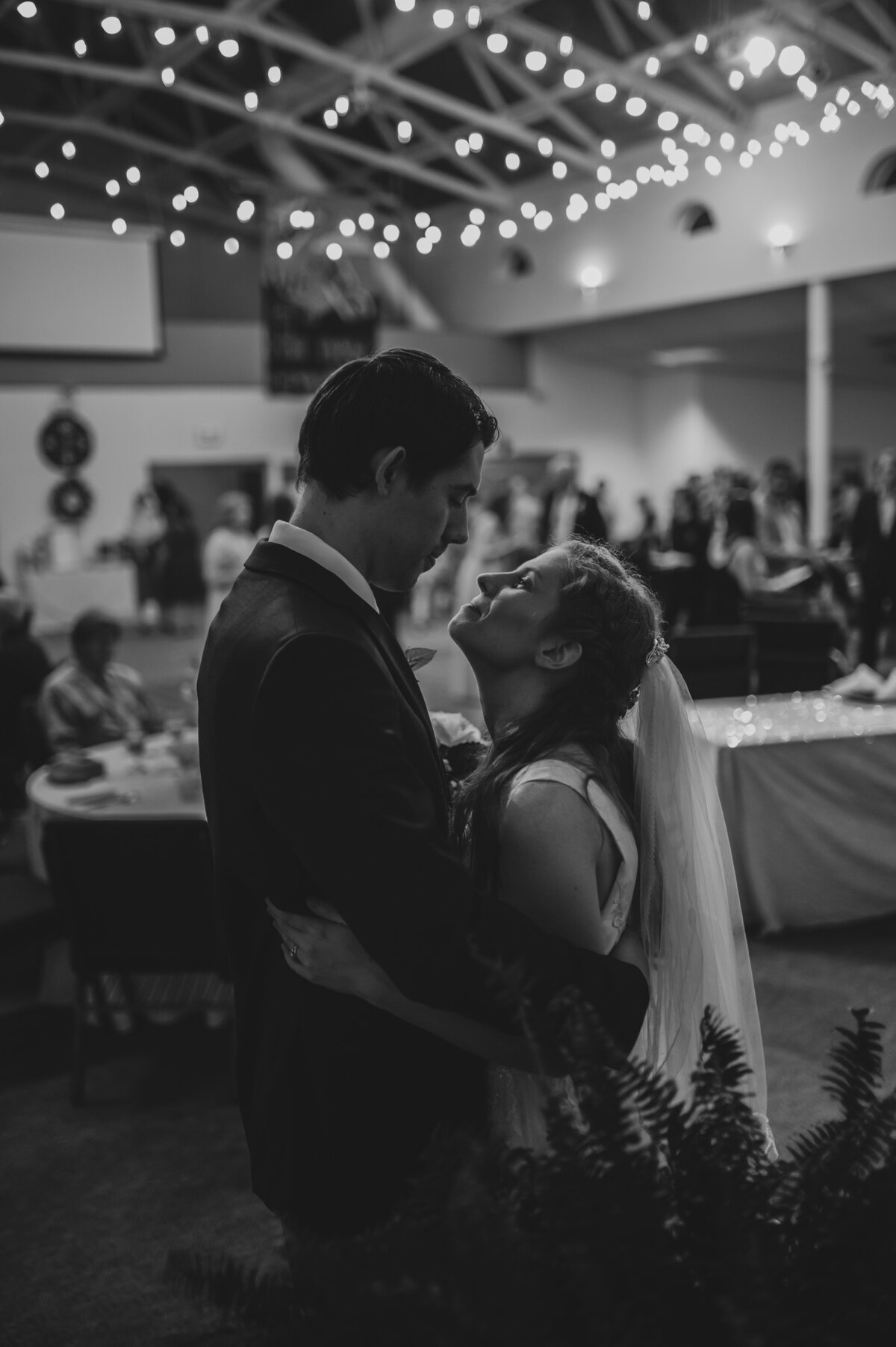 Emotional black-and-white moment as bride and groom share a quiet embrace, filled with love and deep spiritual connection.