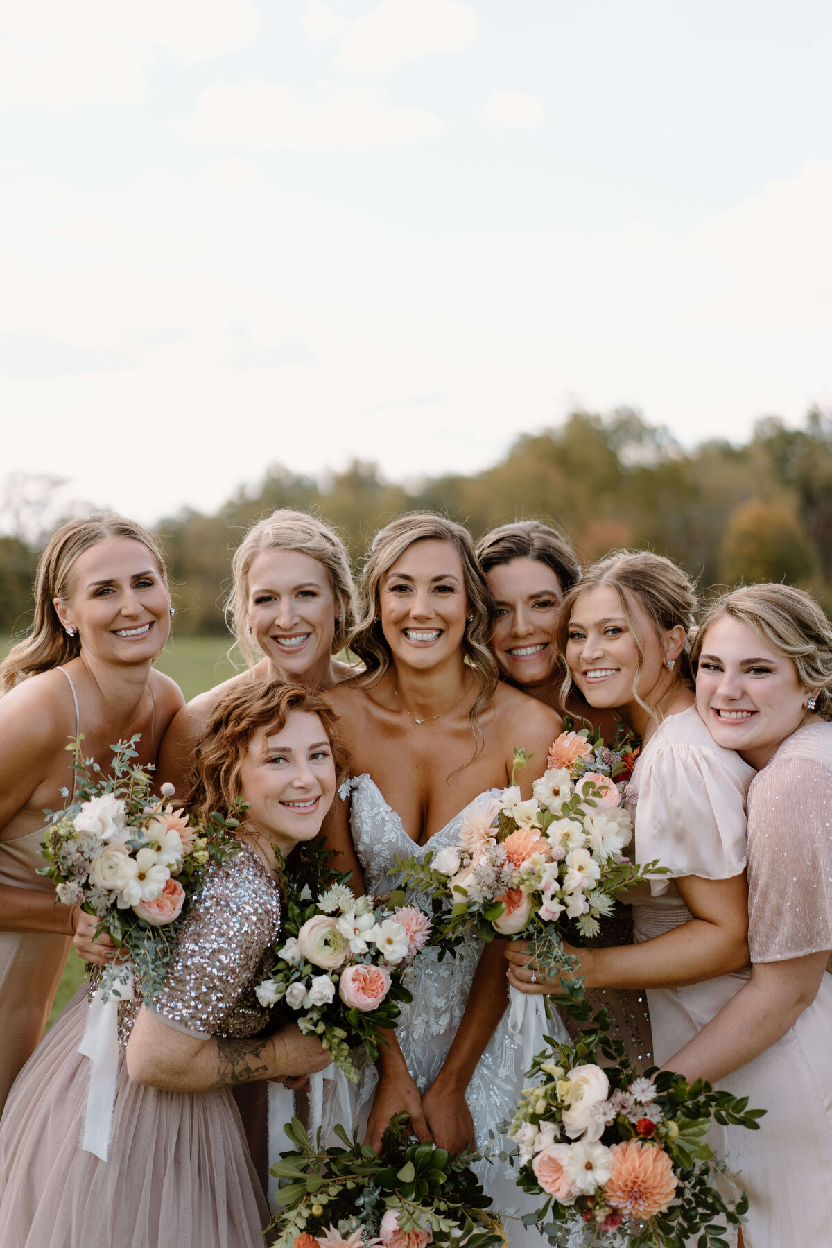 bride with bridesmaid at fall wedding at the barns at Elizabeth farms in Lancaster