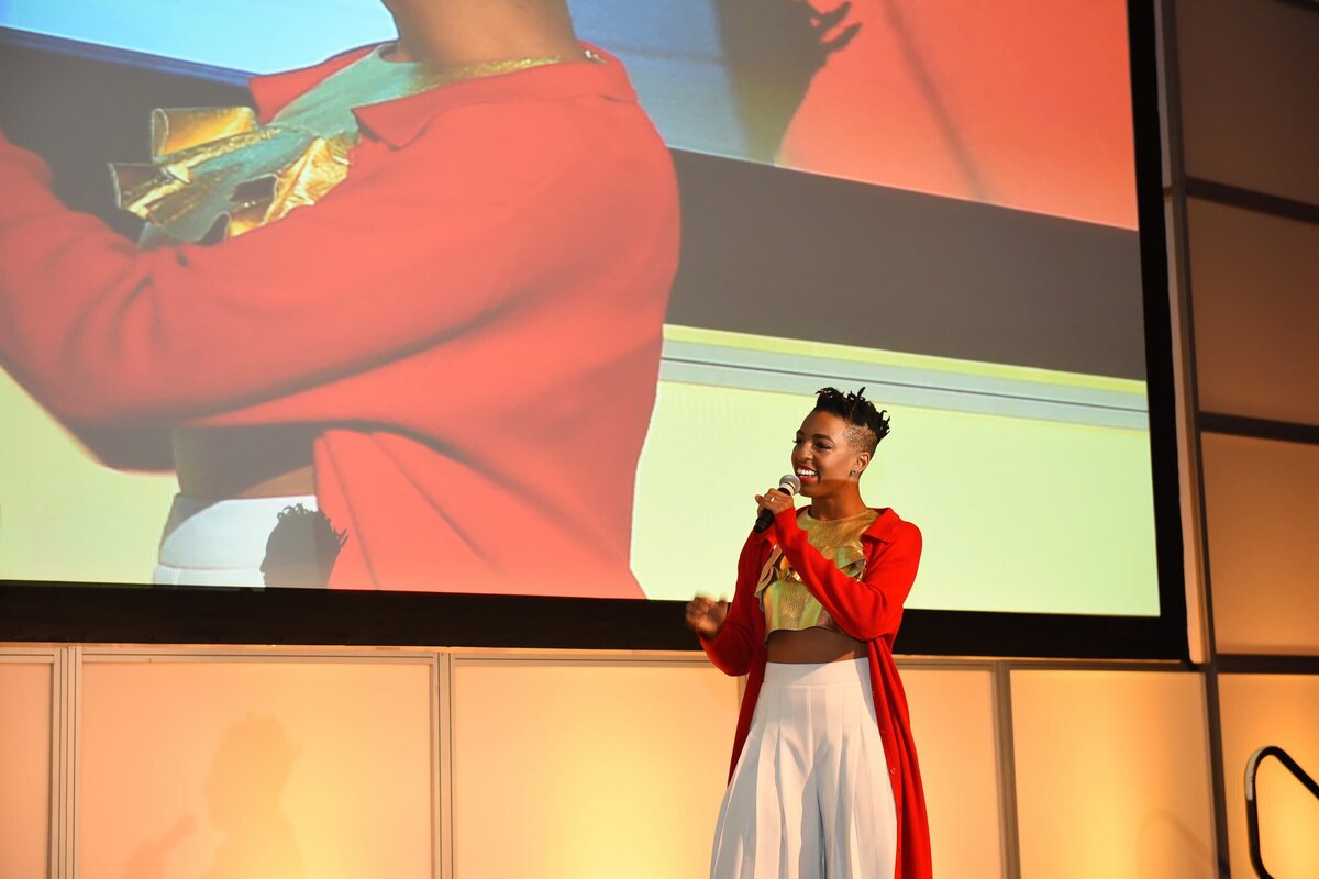 live performer speaking on stage at a corporate event in Toronto, captured by an event photographer.